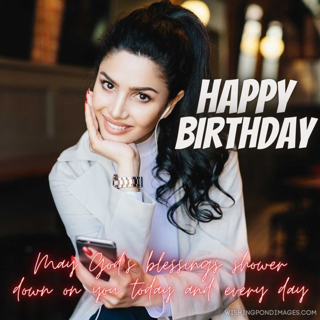 A female having a dark eye long eyelashes, and full well-shaped lips holding her hand on her cheek. 